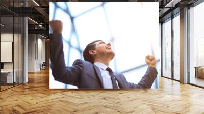 successful happy businessman raises his arms up celebrating his victory Wall mural