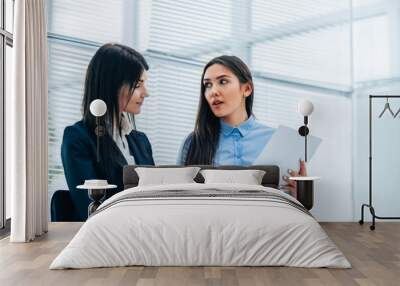 two young employees discussing business documents. photo with copy-space Wall mural