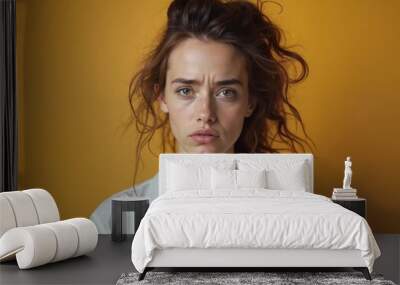 Woman with Distressed Expression Showing Concern Against Yellow Background Wall mural