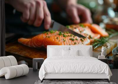 Chef slicing fresh salmon fillet with herbs on a wooden board in the kitchen. Wall mural