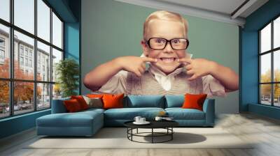 Cheerful smiling funny boy on a green background. Wall mural