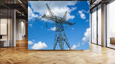 High voltage power line  on a blue sky background. Close-up Wall mural