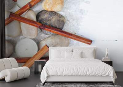 Vertical SPA flat lay. Dry bamboo, sea pebbles, scented candles, sea salt on a light wooden background. Top view Wall mural