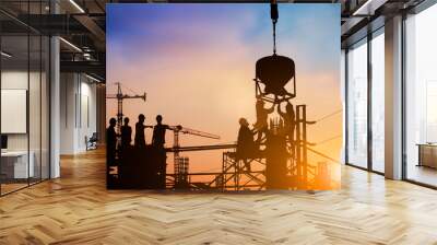 Silhouette of engineer and construction team working at site over blurred background for industry background with Light fair.Create from multiple reference images together Wall mural