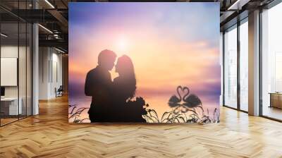 silhouette of romantic lovers over blur nature. valentines day; Wall mural