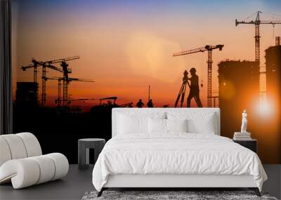 Silhouette of Survey Engineer and construction team working at site over blurred  industry background with Light fair Film Grain effect.Create from multiple reference images together Wall mural