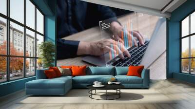 Business growth and financial investment concept. Businessman using laptop for comparative analysis of sales data, economic growth graphs, business planning, strategy, sales, and marketing. Wall mural