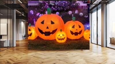 Inflatable pumpkins glowing. Halloween background decoration outside a house front yard. Wall mural