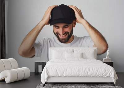 Happy man wearing a black cap mockup isolated on white background Wall mural