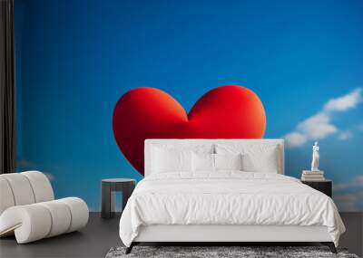 red heart shape on blue sky background Wall mural