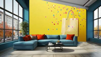 shopping bag with confetti on a yellow background Wall mural