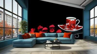 Red coffee cup with rose petals on black background Wall mural