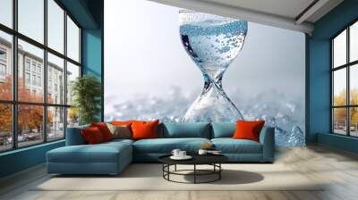 A glass filled with bubbly water, surrounded by splashes. Wall mural