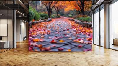 A serene path lined with colorful autumn leaves in a park. Wall mural