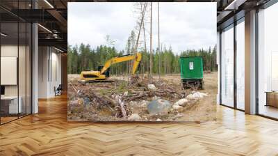 Excavator and cabins for forestry workers on a forest felling plot. Wood industry in Russia Wall mural