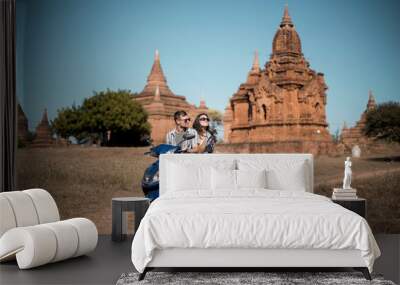 travel couple riding scooter through the ancient temples of bagan myanmar Wall mural