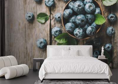 Freshly picked blueberries in wooden bowl on wooden background. Healthy eating and nutrition. Wall mural