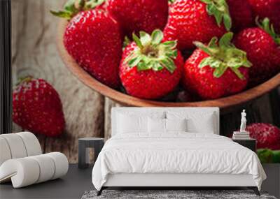 Freshly picked Strawberry in wooden bowl on wooden background. Healthy eating and nutrition. Wall mural