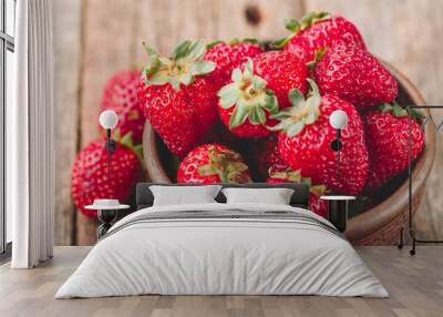 Freshly picked Strawberry in wooden bowl on wooden background. Healthy eating and nutrition. Wall mural