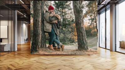 Hiking couple with backpack walking in the forest and exploring outdoors. Freedom and active travel concept. Wall mural