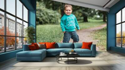 Little boy play in the park. Wall mural