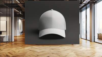 A white hat is sitting on a dark surface Wall mural