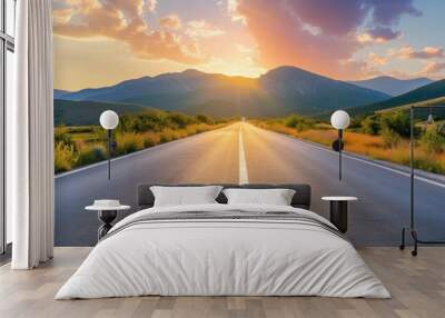 An empty asphalt road leading into the distance, with mountains in the background Wall mural