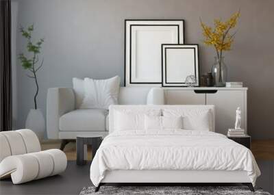 A modern minimalist living room interior, a white lacquered sideboard with geometrically arranged framed artworks placed on top, parquet herringbone hardwood flooring, a white armchair, gray accent wa Wall mural