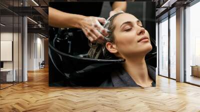 Hairdresser washing woman's hair in hairdresser salon Wall mural