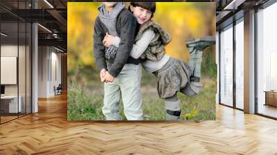 portrait of little boy and girl outdoors in autumn Wall mural