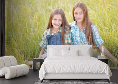 Portrait of two beautiful girlfriends on the nature Wall mural