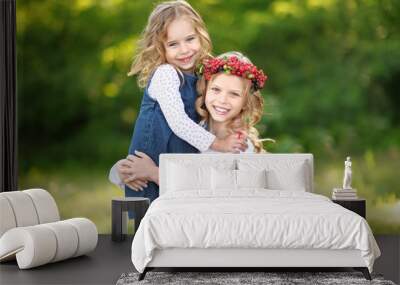 portrait of two little sisters with berries Wall mural