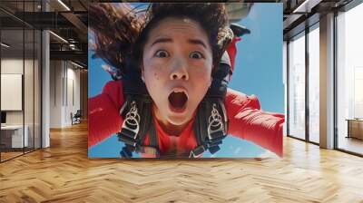 Chinese woman Skydiving Against a Bright Blue Sky. Freedom and Adventure. Extreme Sports, Travel Wall mural