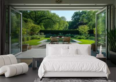 A beautiful garden and patio in summer are seen from a stylish designer room through bifold doors. Wall mural