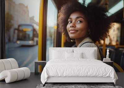 A close-up of an African American woman getting on the bus at the station. Black women who are not well-known board public transportation to go to work or school.   Wall mural