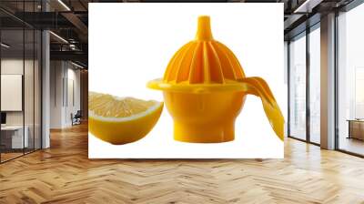 A juicer next to a slice of lemon, ready for fresh juice extraction Wall mural