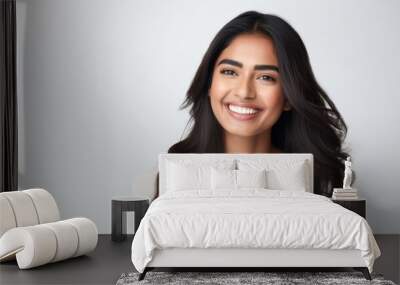 A closeup photo portrait of a beautiful young asian indian model woman smiling with clean teeth. used for a dental ad. isolated on white background Wall mural