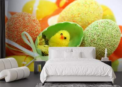 Egg shaped dish holding colorful Easter eggs Wall mural