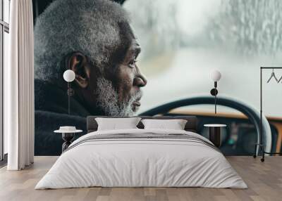 Elderly man driving bus, focused, serious, side view, rain outside, transportation concept Wall mural