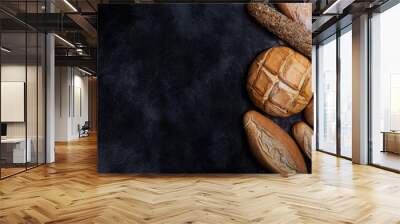 Fresh bread on a black chalkboard. Top view with copy space Wall mural