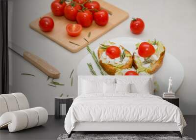 Italian bruschetta with soft cheese, tomatoes, rosemary and fresh salad on the plate. Space for text Wall mural