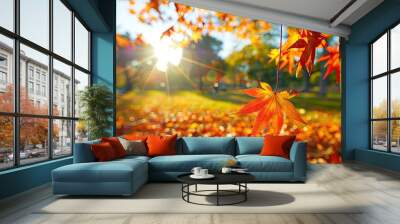 Autumn colorful bright leaves swinging in a tree in autumnal park Wall mural