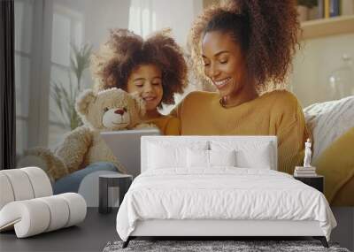 An Afro family browsing the web, a mother and daughter looking for information. Wall mural