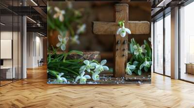 Cross with candles and snowdrops on a table on an abstract background. Christian holiday. Symbol of faith in God, Easter, Palm Sunday, Lent. Wall mural