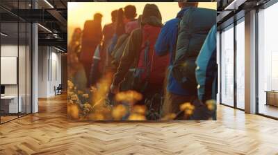 Friends walking with backpacks in sunset. Concept of adventure, travel, tourism, hike, and friendship among people. Wall mural