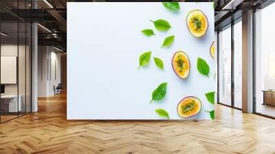 Half-sliced passion fruit floating in the air with green leaves on background. Fresh organic fruit high in vitamins and minerals. Wall mural