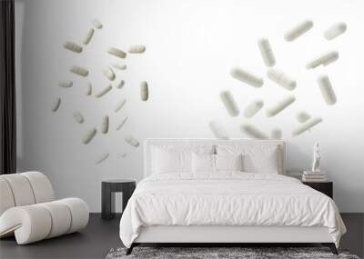 Isolated falling pills with full depth of field, isolated on white Wall mural