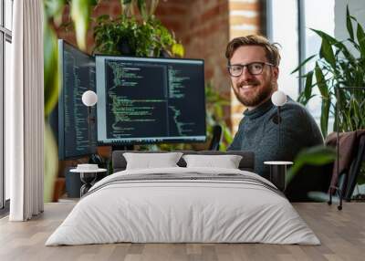 Stylish man working with a computer system inside an office wearing a shirt and working on a netbook Wall mural