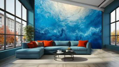 The underwater ocean is illuminated by the sun and has an abyssal blue color - ideal for diving and scuba diving Wall mural