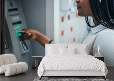 African american woman using credit card and withdrawing cash at the ATM Wall mural